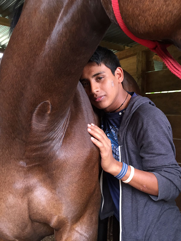 Young boy with a horse at Lead-Up International's program in Guatemala - Lead-Up Guatemala